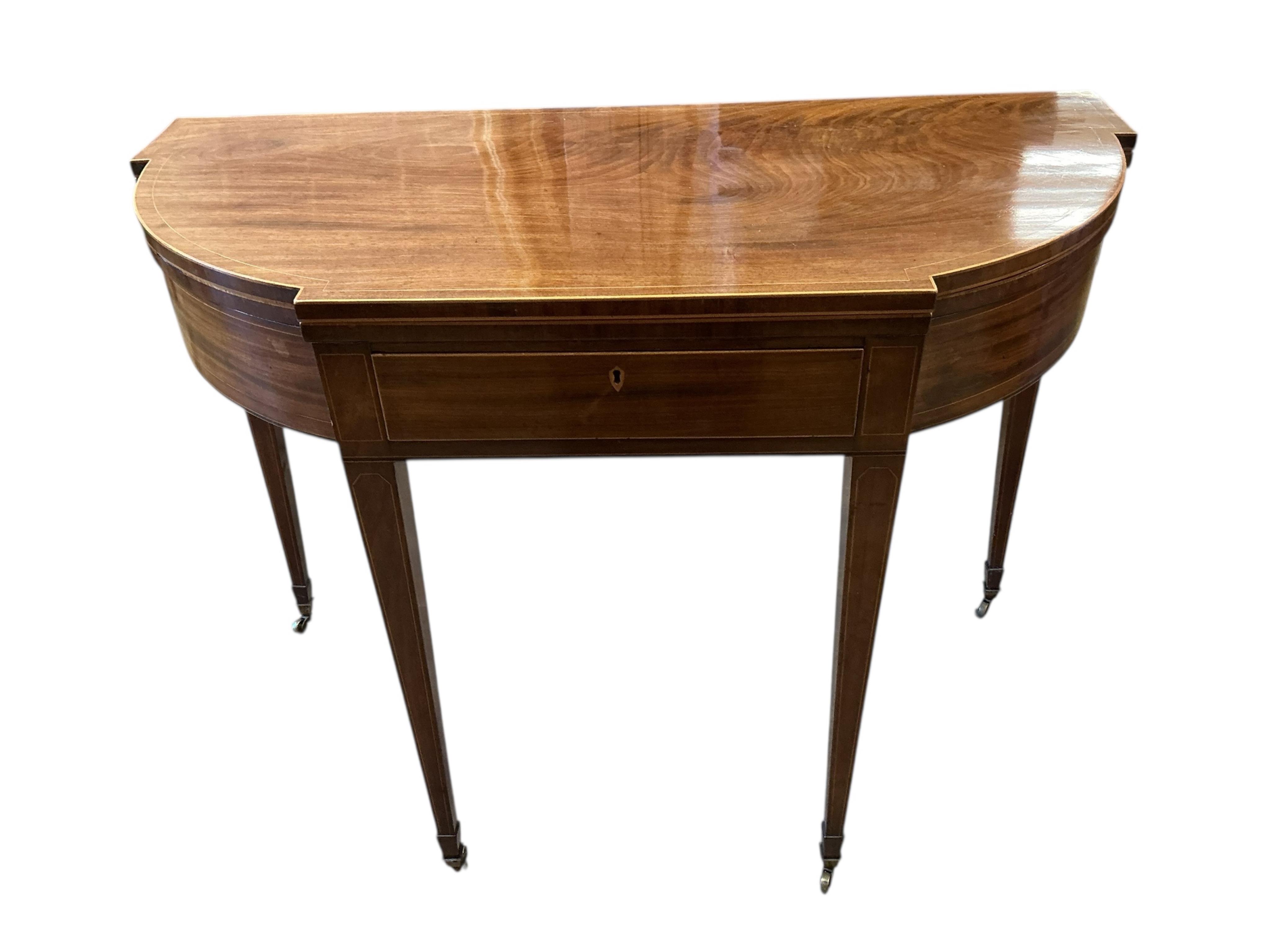 A George III boxwood strung mahogany breakfront folding tea table with frieze drawer, width 101cm, depth 47cm, height 74cm